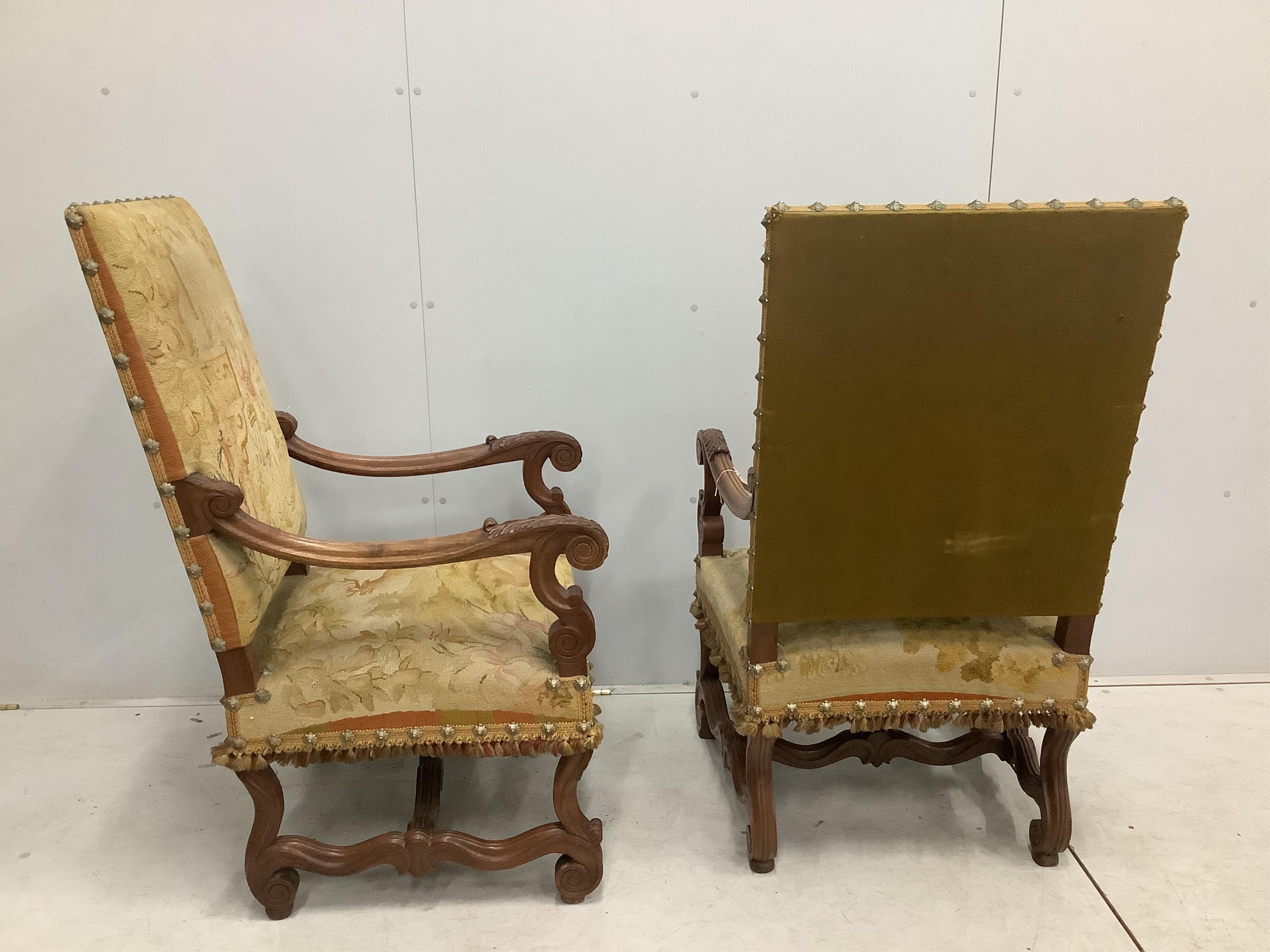 A pair of 18th century style walnut and needlepoint tapestry chairs, width 63cm, depth 64cm, height 114cm. Condition - fair